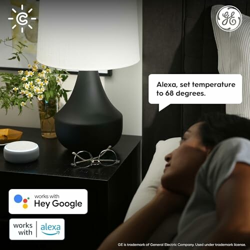 Person in bed using voice control for smart home device.